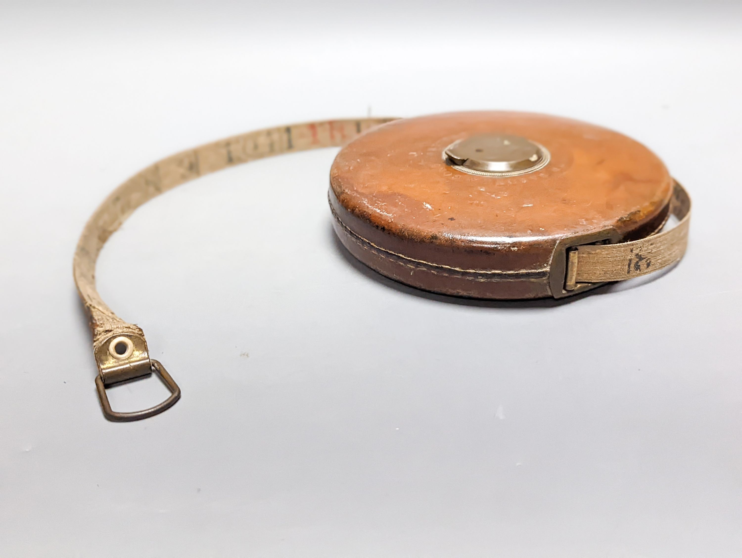 A Victorian cased weighing scale, two papier mache wine coasters and surveyor's measure.